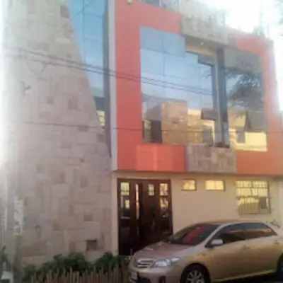 a car parked in front of a building at Hotel Kallma Adventures in Ica