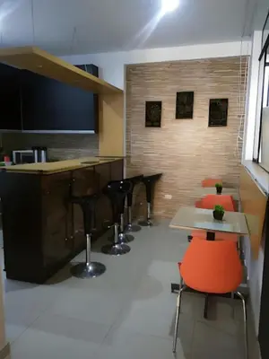 a bar with chairs and tables in a room at Hotel Kallma Adventures in Ica