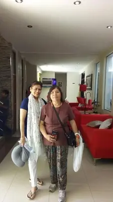 two women are standing in a living room at Hotel Kallma Adventures in Ica