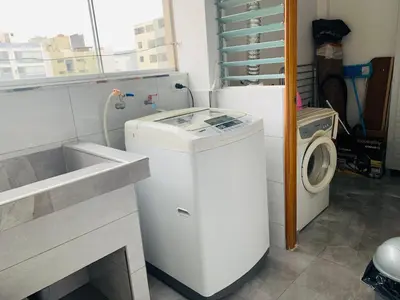 a laundry room with a washing machine and a washer at Spacious apartment in Miraflores in Lima