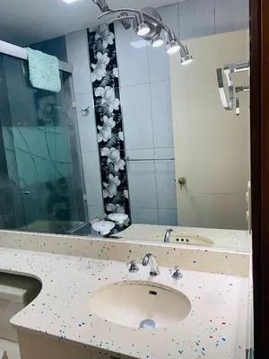 a bathroom with a sink and a large mirror at Spacious apartment in Miraflores in Lima