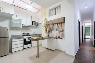 a kitchen with white cabinets and a counter top at Sweet MATERNITY Home & 3 dormitorios, AIRE ACONDICIONADO in Lima