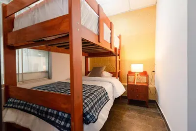 a bedroom with two bunk beds in a room at Sweet MATERNITY Home & 3 dormitorios, AIRE ACONDICIONADO in Lima