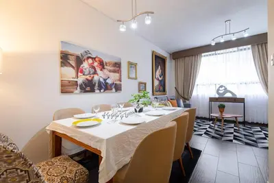 a dining room with a table and chairs at Sweet MATERNITY Home & 3 dormitorios, AIRE ACONDICIONADO in Lima