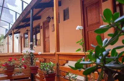 a building with potted plants on the balcony at La Posada del Viajero in Cusco