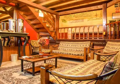 a living room with couches and a table at La Posada del Viajero in Cusco