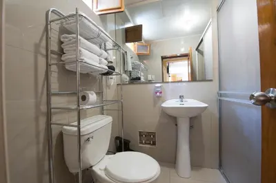 a small bathroom with a toilet and a sink at La Posada del Viajero in Cusco