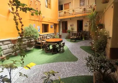 a courtyard with a table and chairs in a building at La Posada del Viajero in Cusco