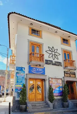 a white building with a sign on it at Illari Wari II-Hotel Sauna in Ayacucho