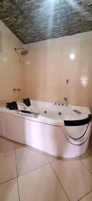 a large white bath tub in a room at Illari Wari II-Hotel Sauna in Ayacucho