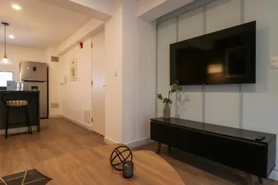 a living room with a flat screen tv on a wall at Monumental by Wynwood House in Lima