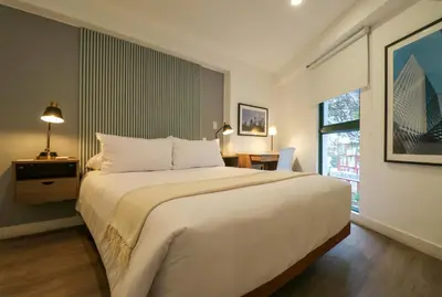 a bedroom with a large white bed and a window at Monumental by Wynwood House in Lima