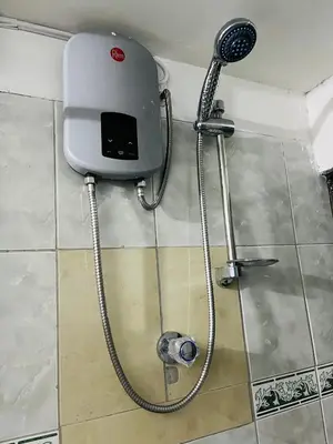 a shower in a bathroom with a shower head at ENEDE HOSTEL in Cusco
