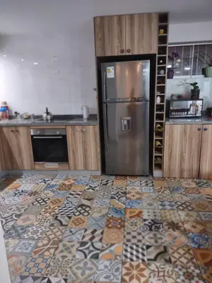 a kitchen with a stainless steel refrigerator in the middle at DEPARTAMENTO RECAVARREN (SURQUILLO/MIRAFLORES) in Lima