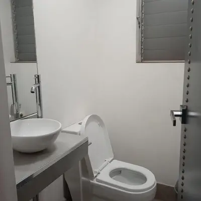 a bathroom with a white toilet and a sink at DEPARTAMENTO RECAVARREN (SURQUILLO/MIRAFLORES) in Lima