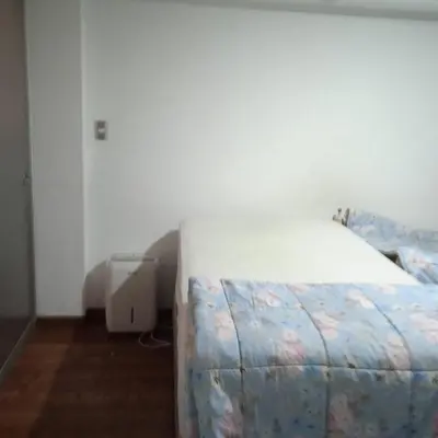 a bedroom with a bed in a room with at DEPARTAMENTO RECAVARREN (SURQUILLO/MIRAFLORES) in Lima