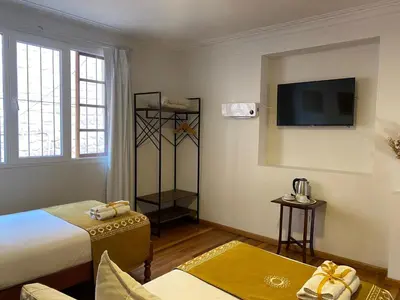 a hotel room with a bed and a flat screen tv at Katari at Plaza de Armas Cusco in Cusco