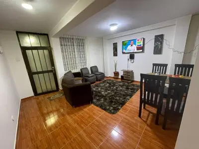 a living room with a couch and a table at Departamento D&C I entero acogedor in Huancayo