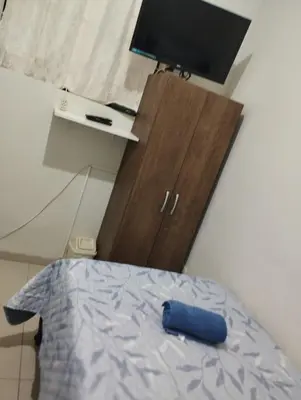 a bedroom with a bed and a dresser with a tv at Barranco monumental in Lima