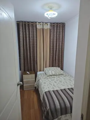 a small bedroom with a bed and a window at Dpto PARQUE SAN FELIPE in Lima