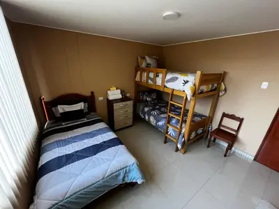 a bedroom with a bed and a bunk bed at Matty House in Lima