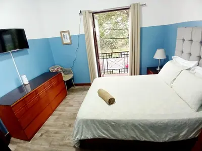 a bedroom with a large bed and a window at Miraflores Kennedy Park in Lima