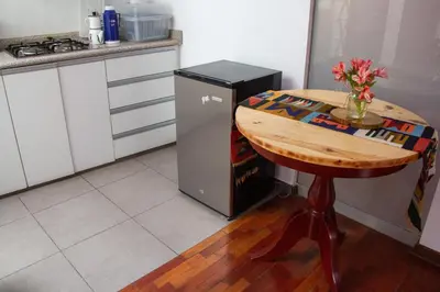 a kitchen with a table and a refrigerator and a table at Apartamento Altoandino in Ayacucho