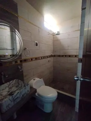 a bathroom with a toilet and a sink and a tub at Hostal El Edén Huaral in Huaral