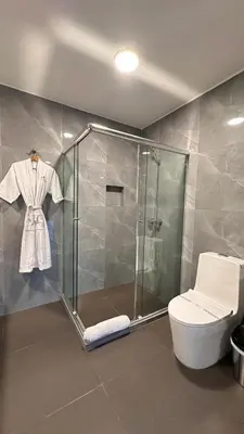 a bathroom with a shower stall and a toilet at Serenzza Hotel in Lima