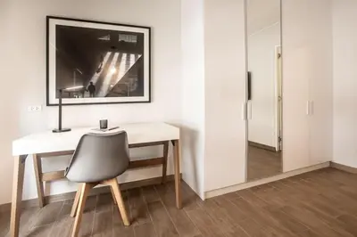 a white desk with a chair and a mirror at SoHo by Wynwood House in Lima