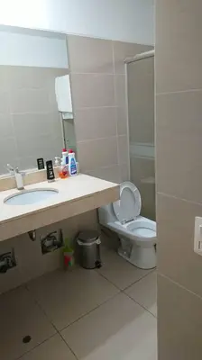 a bathroom with a sink and a toilet and a mirror at Elegante Flat en inmejorable ubicación - San Isidro in Lima