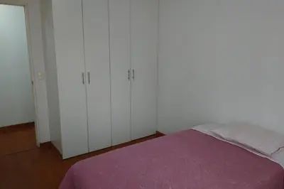 a bedroom with white cabinets and a purple bed at Elegante Flat en inmejorable ubicación - San Isidro in Lima