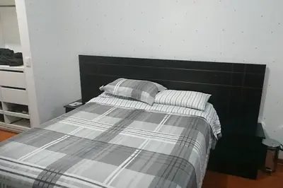 a bed with two pillows on it in a bedroom at Elegante Flat en inmejorable ubicación - San Isidro in Lima
