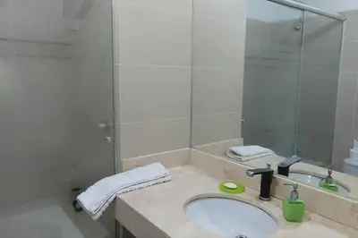 a bathroom with a sink and a mirror at Elegante Flat en inmejorable ubicación - San Isidro in Lima