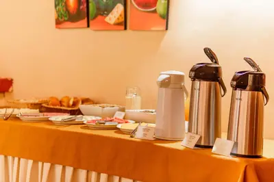 a table with two kettles and plates of food at LILIUM VALLEY in Ollantaytambo