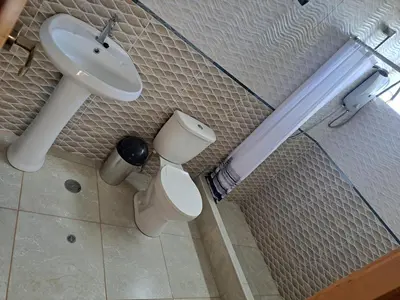 a bathroom with a sink and a toilet at Maychu's Albergue in Chinchero