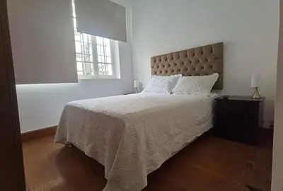 a bedroom with a large bed and a window at La Casona Hospedaje in Lima