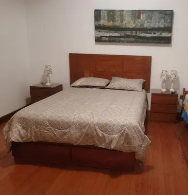 a bedroom with a large bed and two night stands at La Casona Hospedaje in Lima