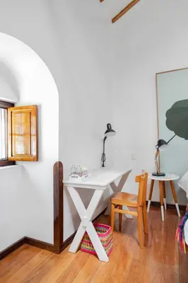 a white desk in a room with a table and chairs at Andenes in Cusco