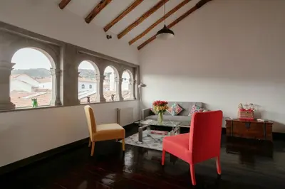 a living room with a table and two chairs at Andenes in Cusco