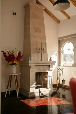 a living room with a fireplace with three candles at Andenes in Cusco