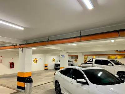 a white car parked in a parking garage at Hotel Las Palmeras in Huacho