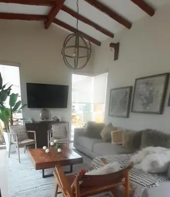a living room with a dog laying on a couch at Kuyayky Lodge in Lima