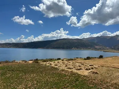 a large body of water with mountains in the background at KanchayKillaWasi in Chinchero