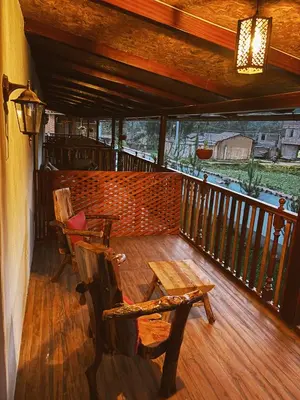 a porch with chairs and a table on a balcony at Hotel Vista Verde in Huancayo