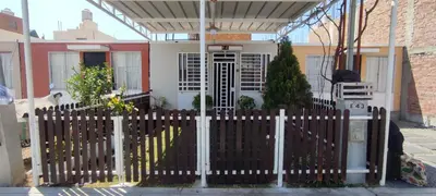 a white picket fence in front of a house at Casa Club Vacacional in Ica
