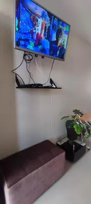a flat screen tv hanging on a wall at Casa Club Vacacional in Ica