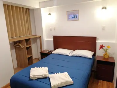 a bedroom with a blue bed with two towels on it at El Ave Azul Boutique Hotel Cusco in Cusco