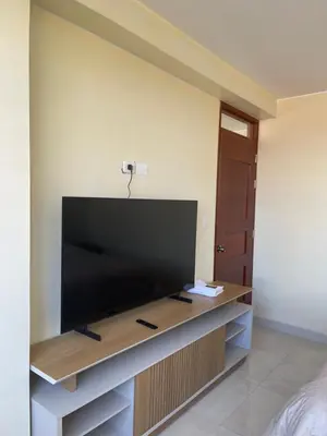 a living room with a large flat screen tv at Casa Galarza in Huancayo
