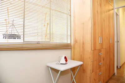 a small white table in a room with a window at Departamento Hermoso en Residencial - Huacachina in Ica